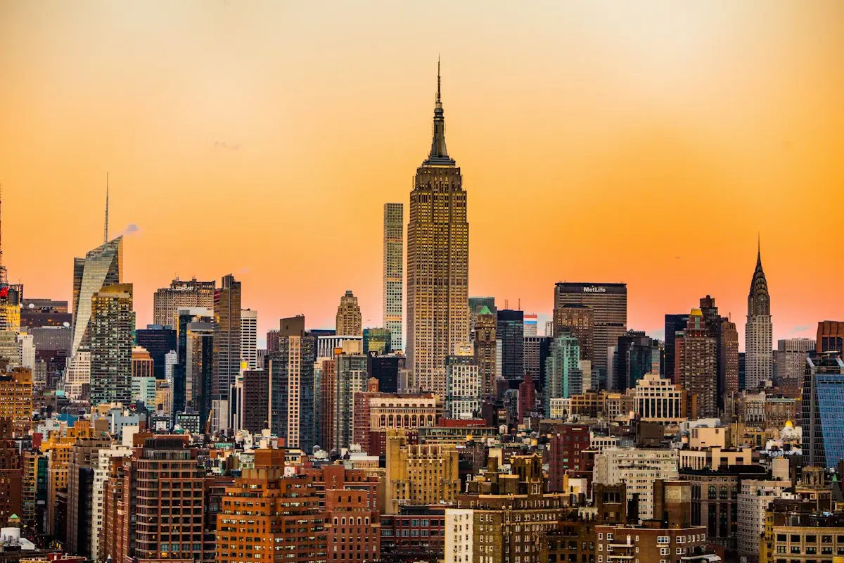 Manhattan skyline at sunset with yellow taxis on the street